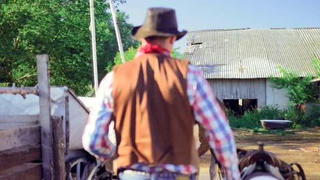 cowboy to feed the horse from a bucket