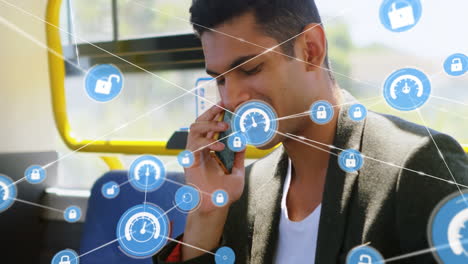 red de iconos digitales contra un hombre biracial hablando en un teléfono inteligente sentado en el autobús