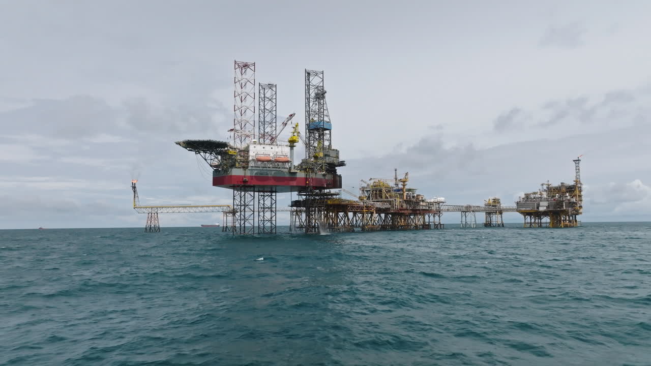 Dolly shot of offshore processing platform near Vietnam coast, oil and gas industry