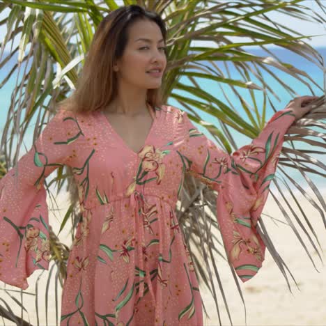 Trendy-lady-near-palm-leaves-on-beach