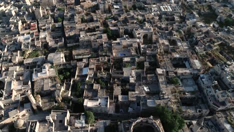 aerial view with a drone over the rooftops of a district of aleppo. we can see the roofs of the buildings of the syrian city under the sunlight 4k