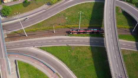 top view over road junctions and public transport with tram driving on tram line