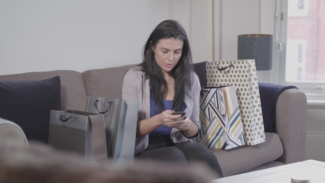 Young Lady Searches For An Item She Has Forgotten To Buy Then Uses Smart Phone To Order It Online - Ungraded