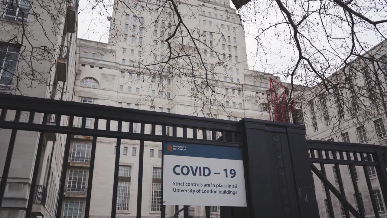 London - Empty Streets - Senate House Library, University of London with Covid-19 warning sign outside (Pandemic, April 10, 2021)