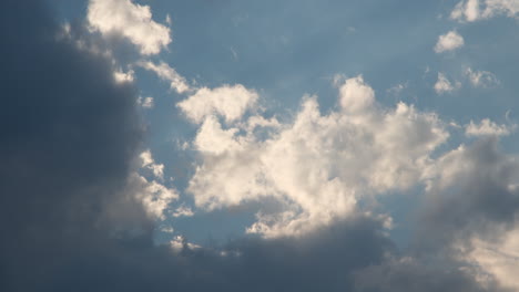 Moving-summer-clouds-time-lapse-against-blue-sky-and-sun-rays