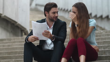 businesswoman gesturing hands outside. business couple analyzing statistics