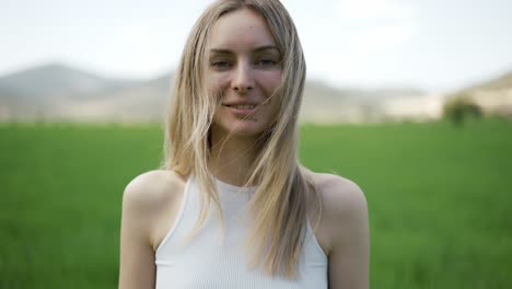 charming woman on a background of mountain landscape and green field