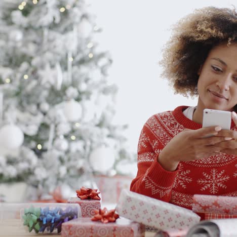 Young-woman-checking-for-Xmas-messages