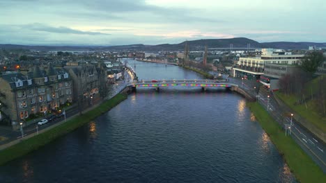 vehicles passing on bridge over ness river in inverness