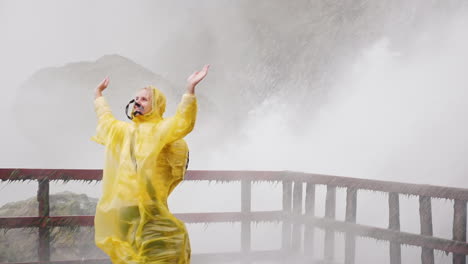 woman admires power of niagara falls