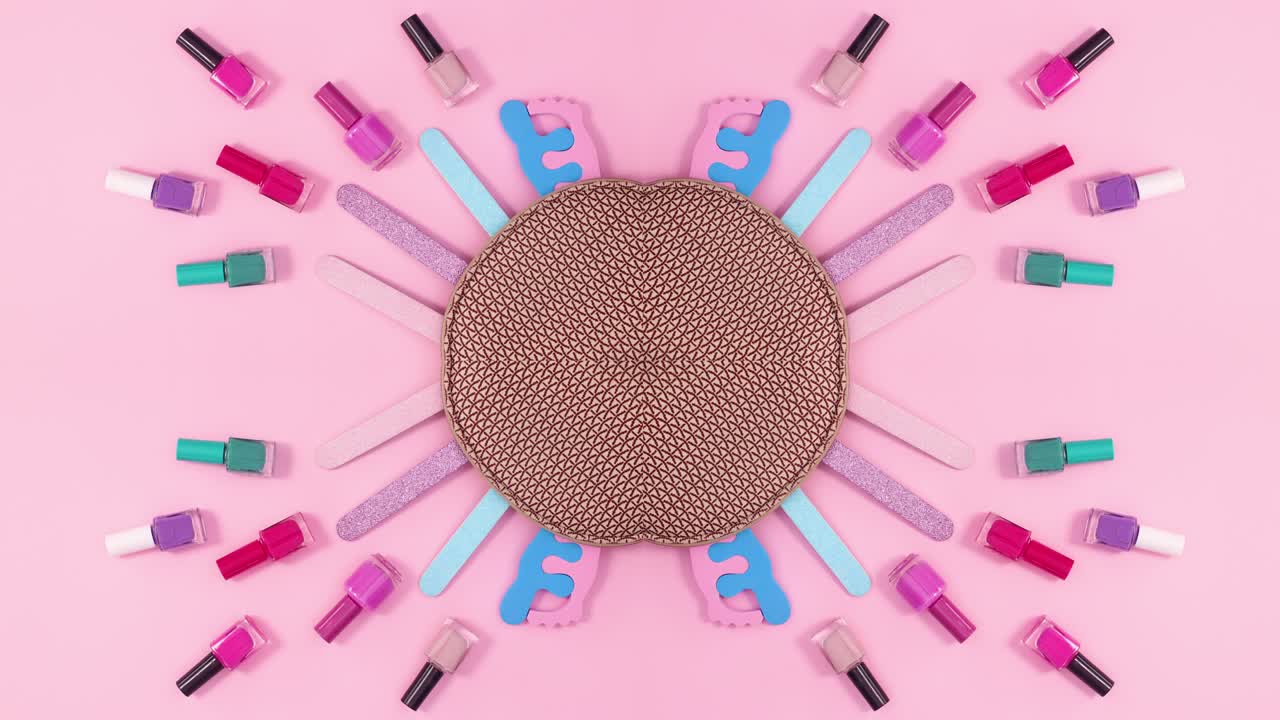 Manicure set move next to kit on pink  background. Stop motion flat lay