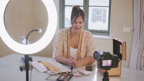 caucasian blogger woman doing a video at home