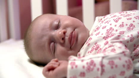 Close-Up-Of-Baby-Girl-Sleeping-In-Nursery-Cot