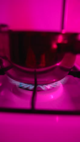 cooking on a gas stove with pink light