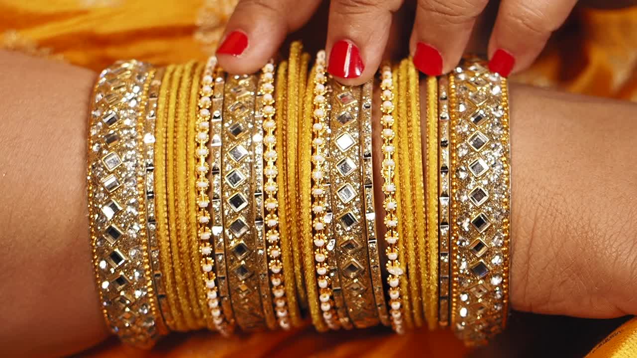 Woman Wearing Multiple Layered Gold Bangles