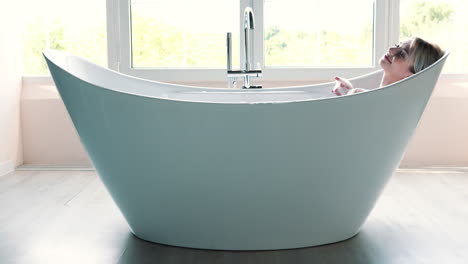 woman relaxing in a modern bathtub