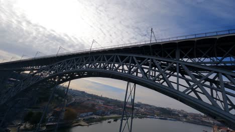 flying drone in crazy spins over water fpv drone dom luis bridge porto portugal