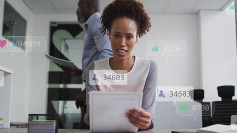 animation of icons and numbers over african american businesswoman in office