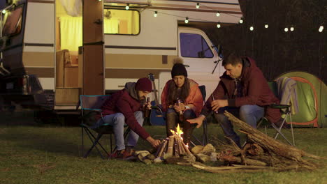 friend of a couple helping to light the camp fire