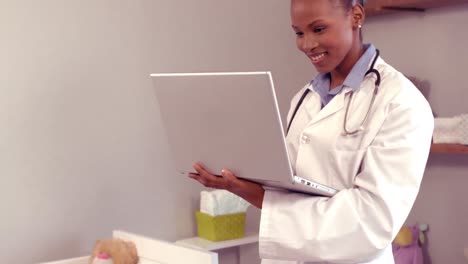 Smiling-doctor-looking-at-her-computer