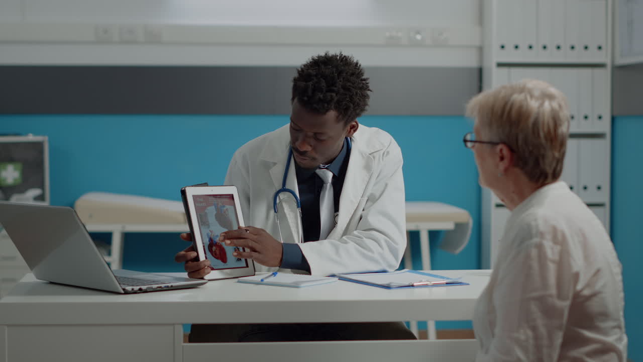 Doctor and senior patient looking at heart picture