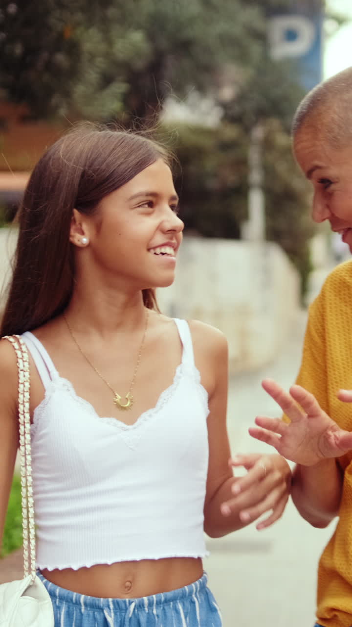 Happy Girl and Mother Talking Outdoors