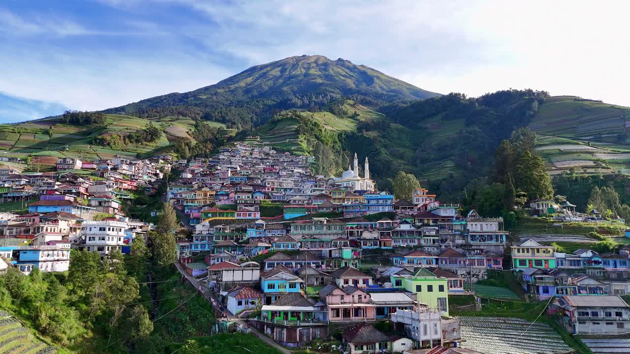 Aerial panorama of a picturesque Indonesian village with colorful houses climbing up the slope of Mount Sumbing. Nepal Van Java, Indonesia