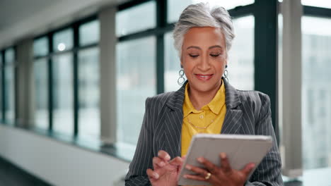 mature businesswoman using tablet in modern office