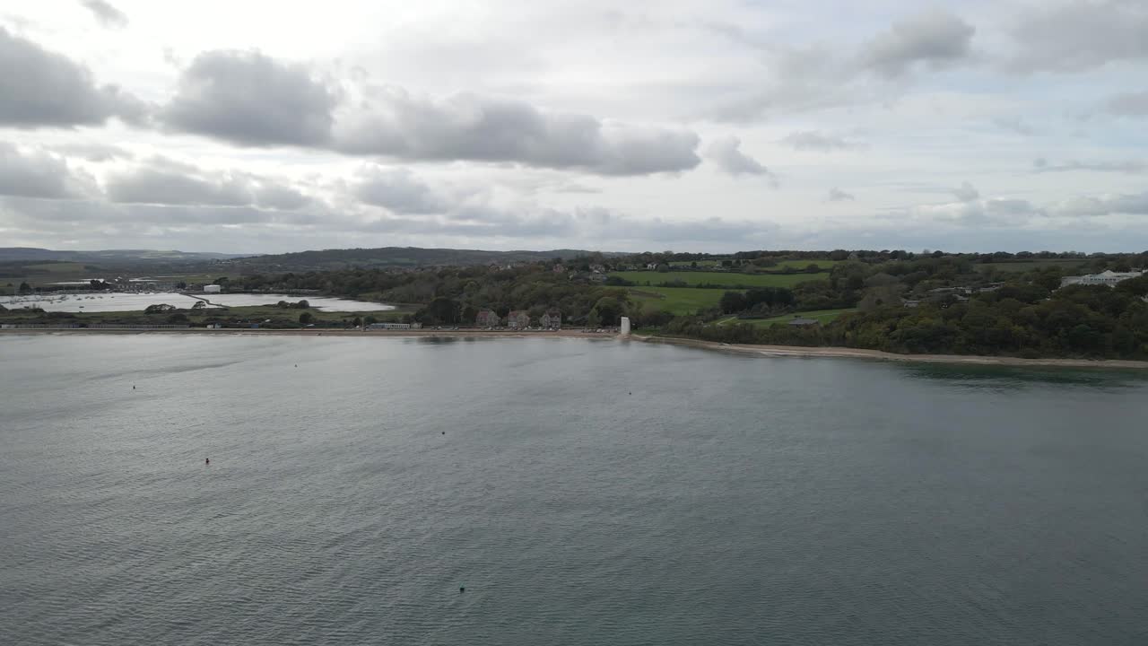 Aerial view of St Helens village named in dedication to St Helena Church, a destroyed church built in the 12th century, Cluniac priory. Only the tower of the church remains, drone going forward