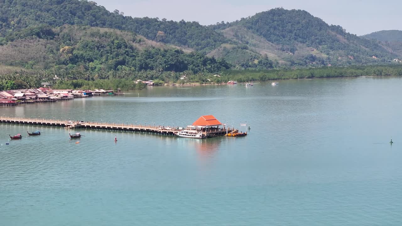 Pier and Lanta Old Town on the island shore, beautiful scenery of rural Thailand. Drone aerial