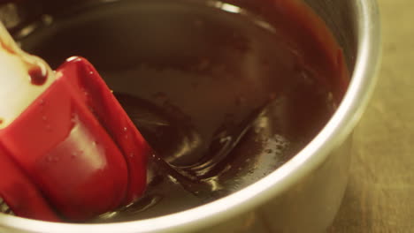 closeup mixing chocolate in slow motion. process of cooking chocolate