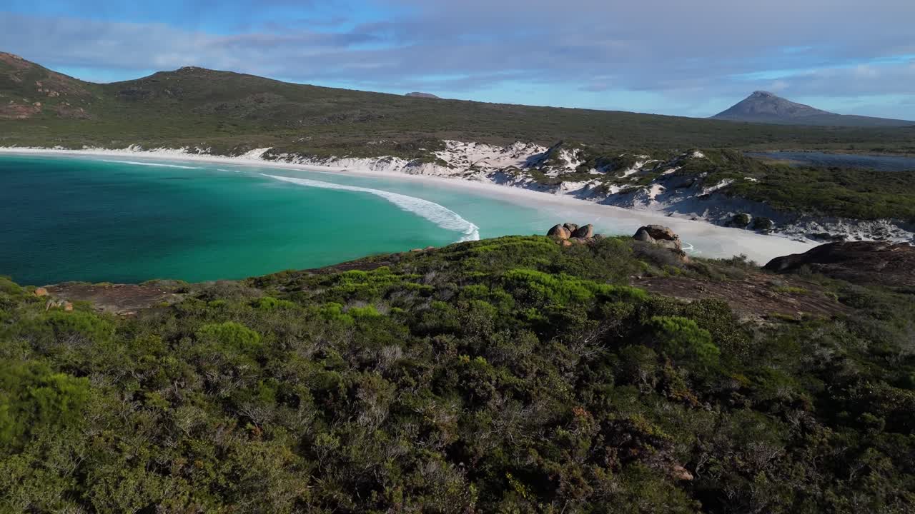 Drone flying through rocks to reveal stunning white sand beach in Esperance, Western Australia