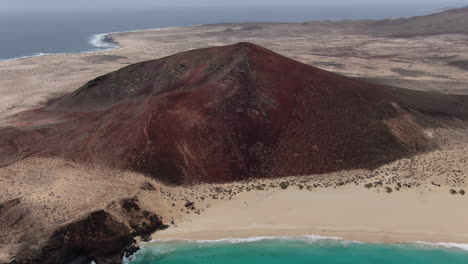 rotating drone shot of the mountain of playa de las conchas on the la graciosa island near lanzarote, spain