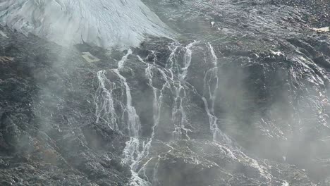 Tele-view-of-many-small-rivers-forming-from-the-molten-water-of-a-remote-alpine-glacier