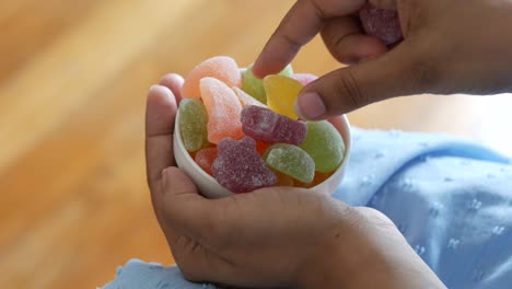 person eating colorful jelly candies