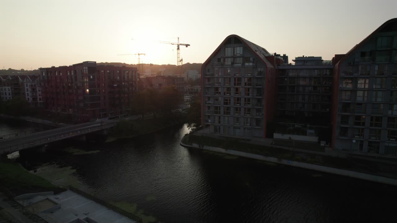 Sunset over Modern City Buildings and Canal