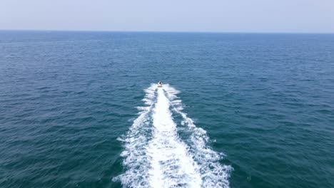 도크에서 멀리 제트 스키를 타는 남자의 훌륭한 공중 샷