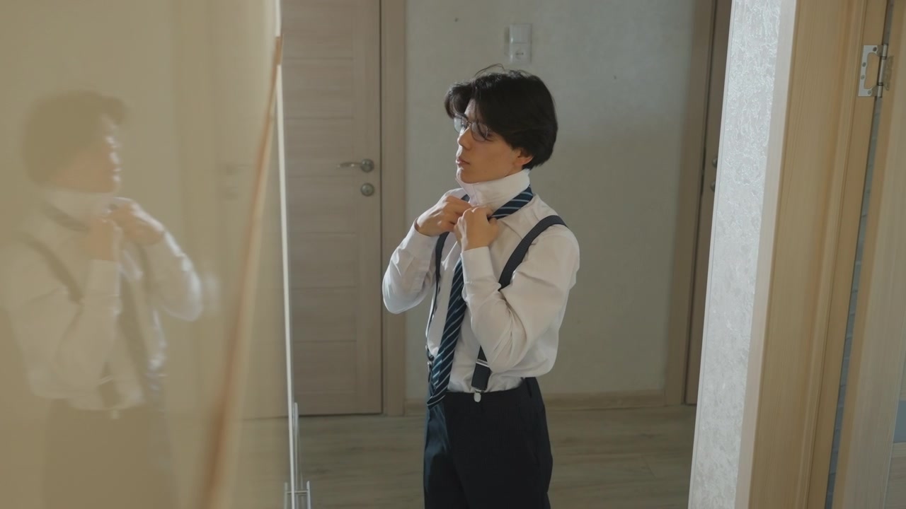 Young man adjusting tie in mirror, morning corridor scene shows nervous applicant preparing for interview buttoning shirt, tightening suspenders and practicing confident smile soft warm light, vintage