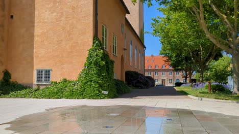 4K-60FPS-Close-to-Ground-View-of-a-Swedish-Church-in-Sweden-Scandinavia-With-a-Fountain-Outside