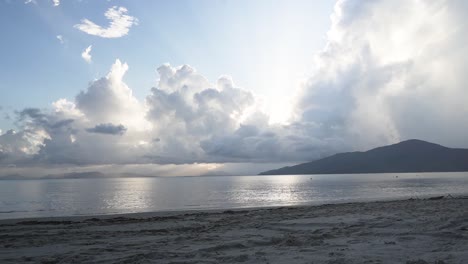 sunset beach timelapse with sunbeams trough the clouds