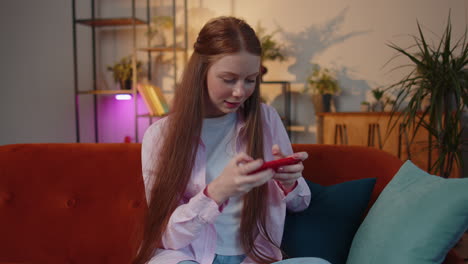 Worried-funny-young-teen-child-girl-kid-playing-racing-online-video-games-on-smartphone-at-home