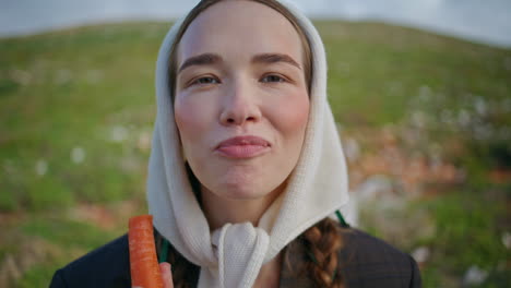 woman biting fresh carrot healthy vegetable closeup. happy vegetarian enjoying