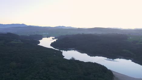 Tidal-river-delta-estuary,-wild-Spanish-coastal-habitat,-sunset-AERIAL