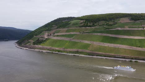 Excursion-boat-navigating-past-Ehrenfels-castle-on-River-Rhine,-Germany