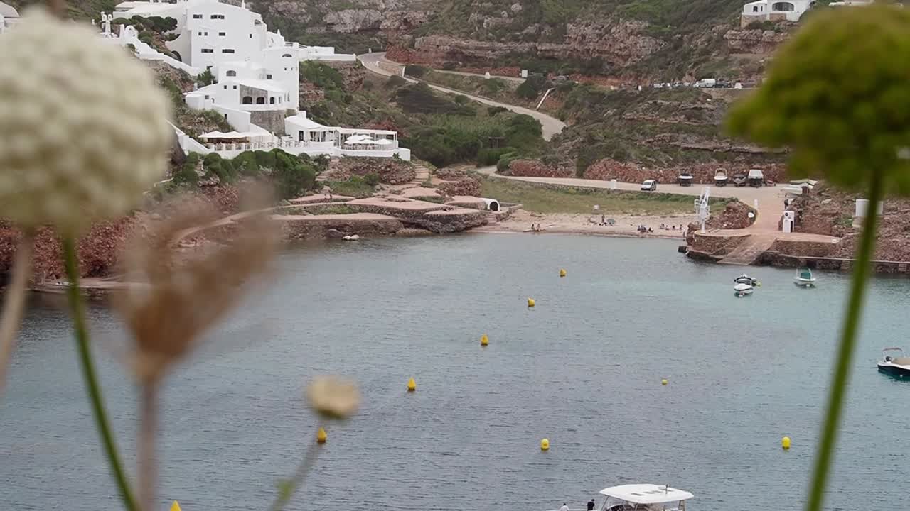 Cala Morell panoramic view, Menorca, beach, boats, clear water, and coastal scenery