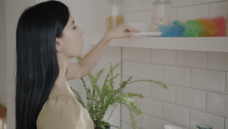 woman organizing kitchen shelves