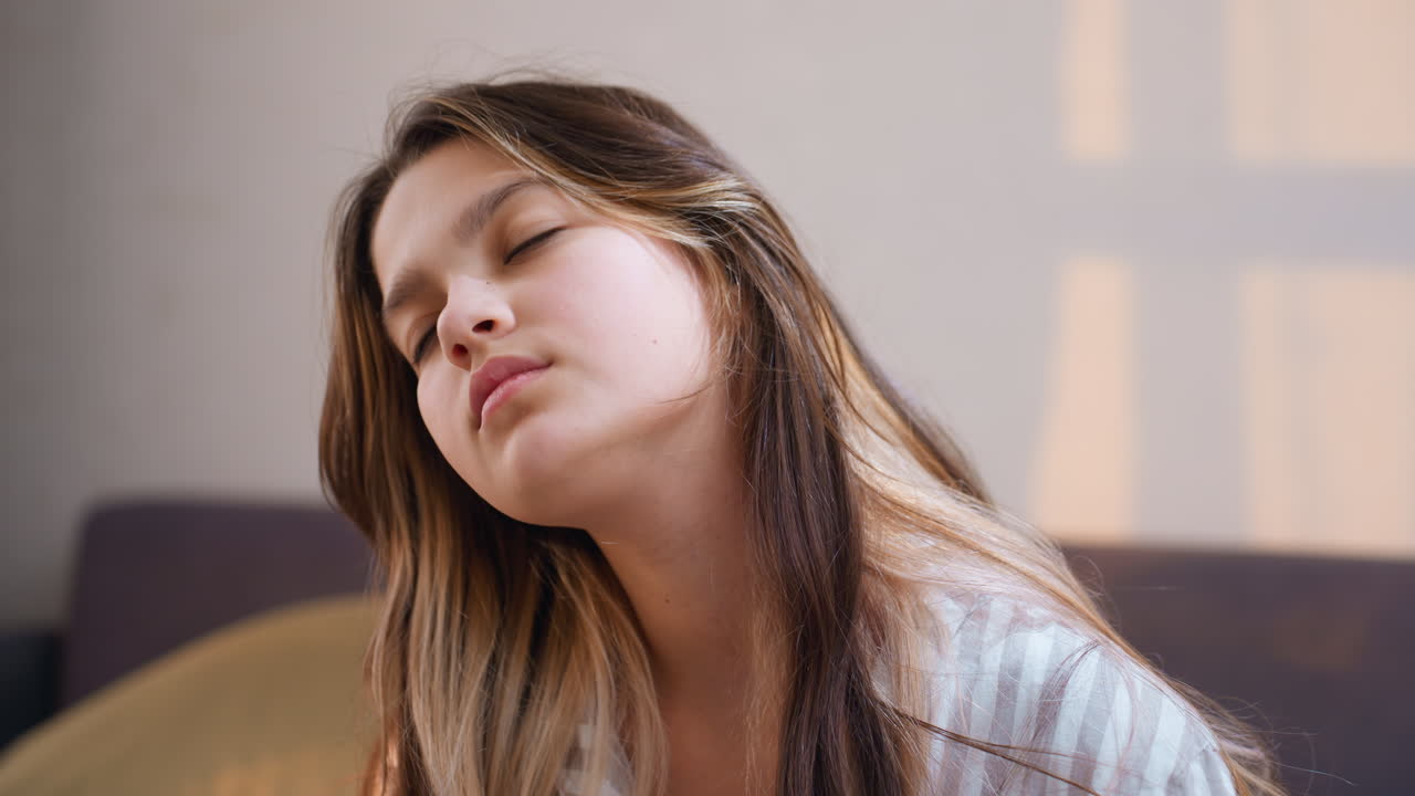 Sleepy Teen Relaxing, Caucasian Youth Relaxing On Sofa In Gentle Sunlight After Studying, Drowsy Teenage Boy Lying On Sofa With Peaceful Expression In Soft Afternoon Light After Studying