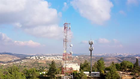 telecommunication towers over israeli cityscape