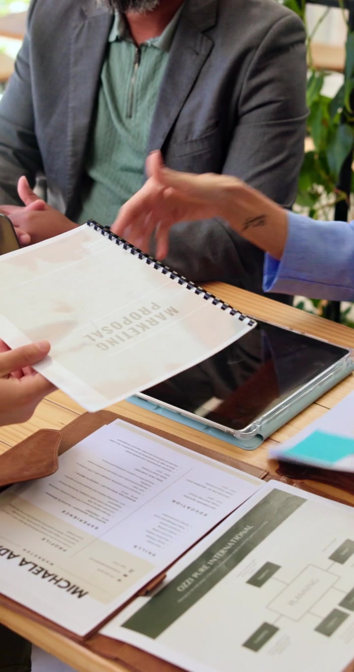 Business Professionals Reviewing Marketing Proposal in Office Meeting