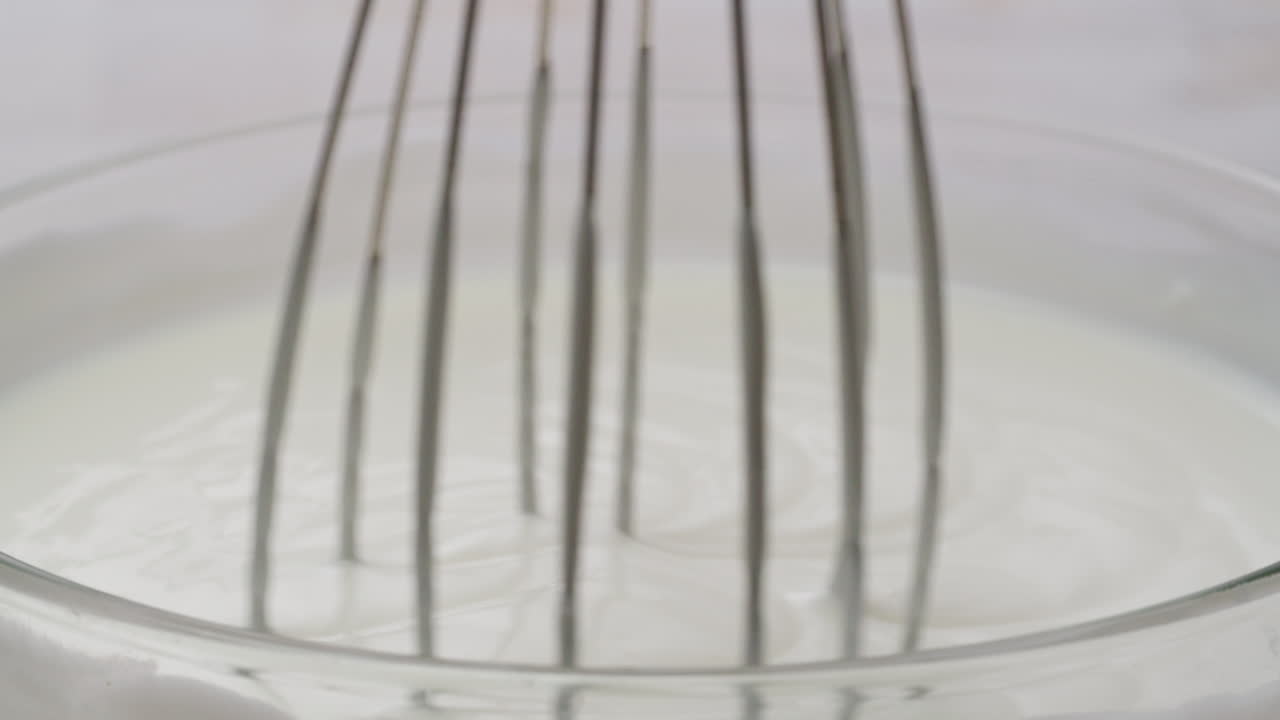 Whipping Cream in a Glass Bowl